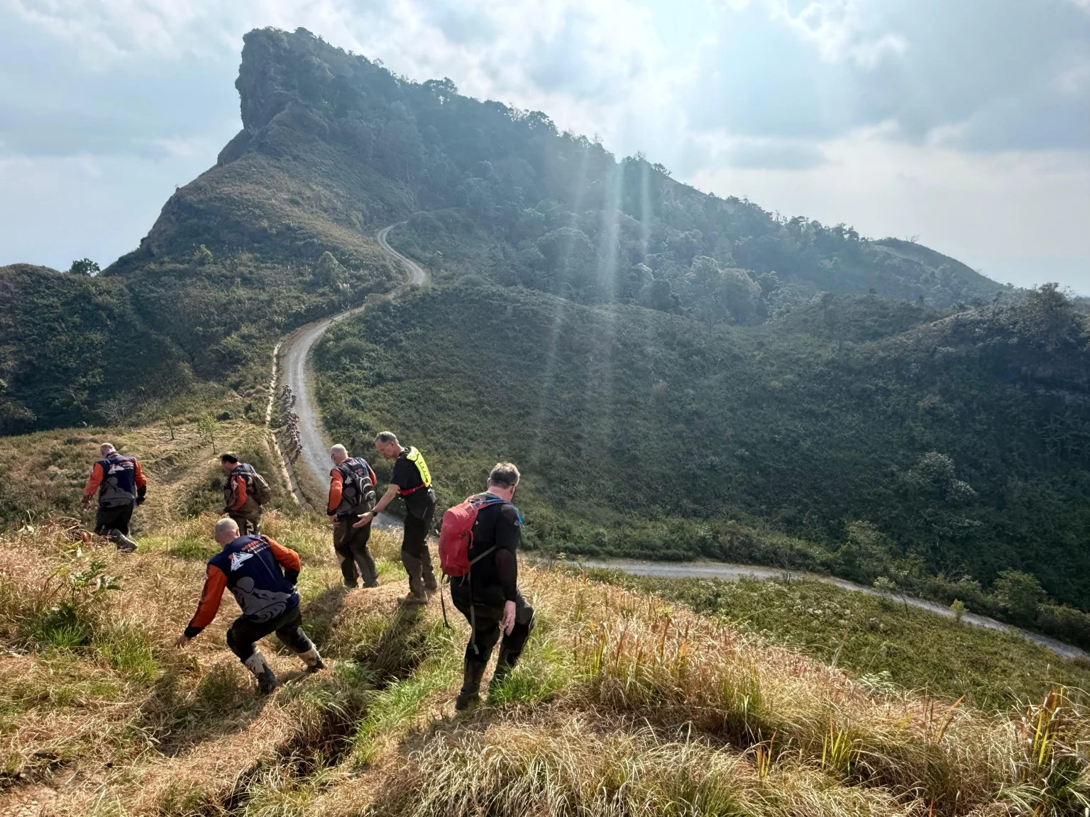 Riders crossing a mountain route in northern Laos