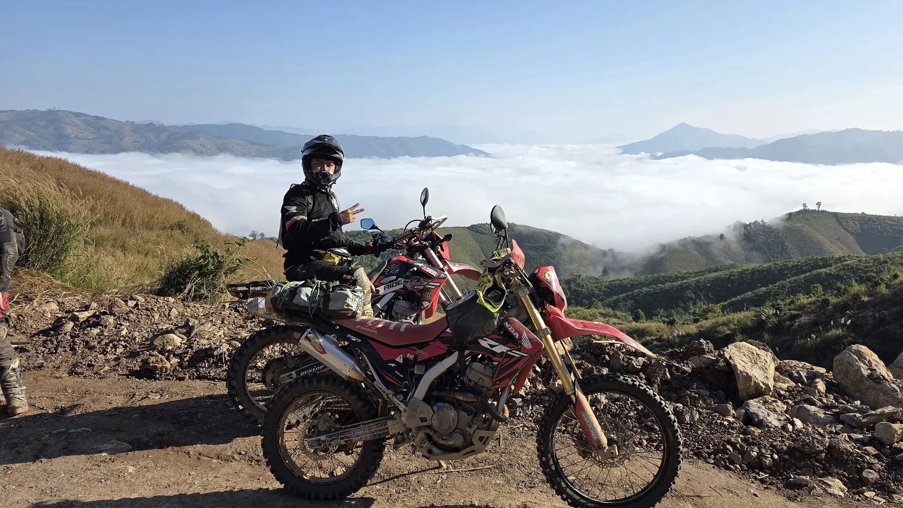 Dirt bike rider above the clouds in northern Laos