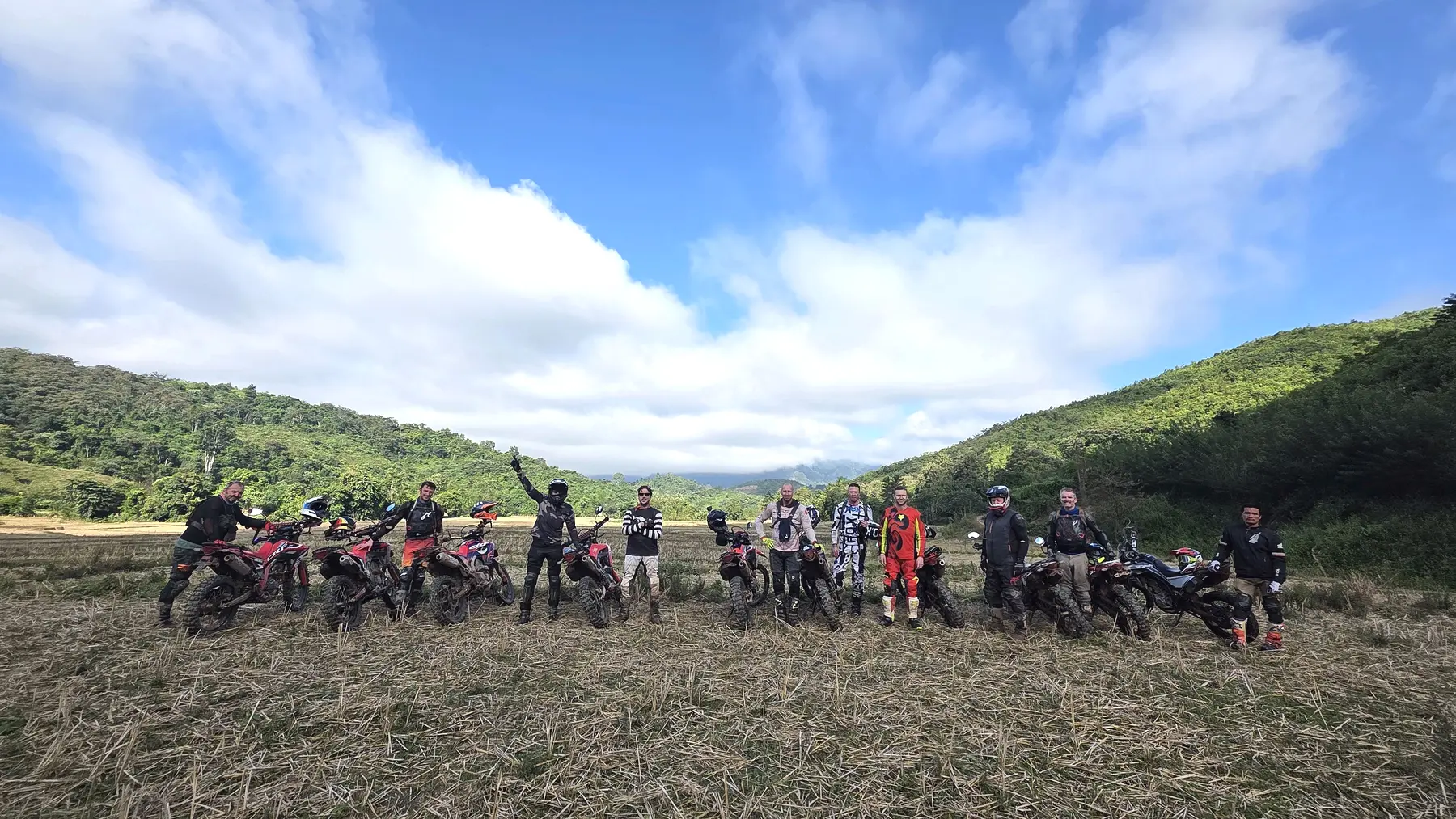 Northern Laos dirt bike expedition team with motorcycles