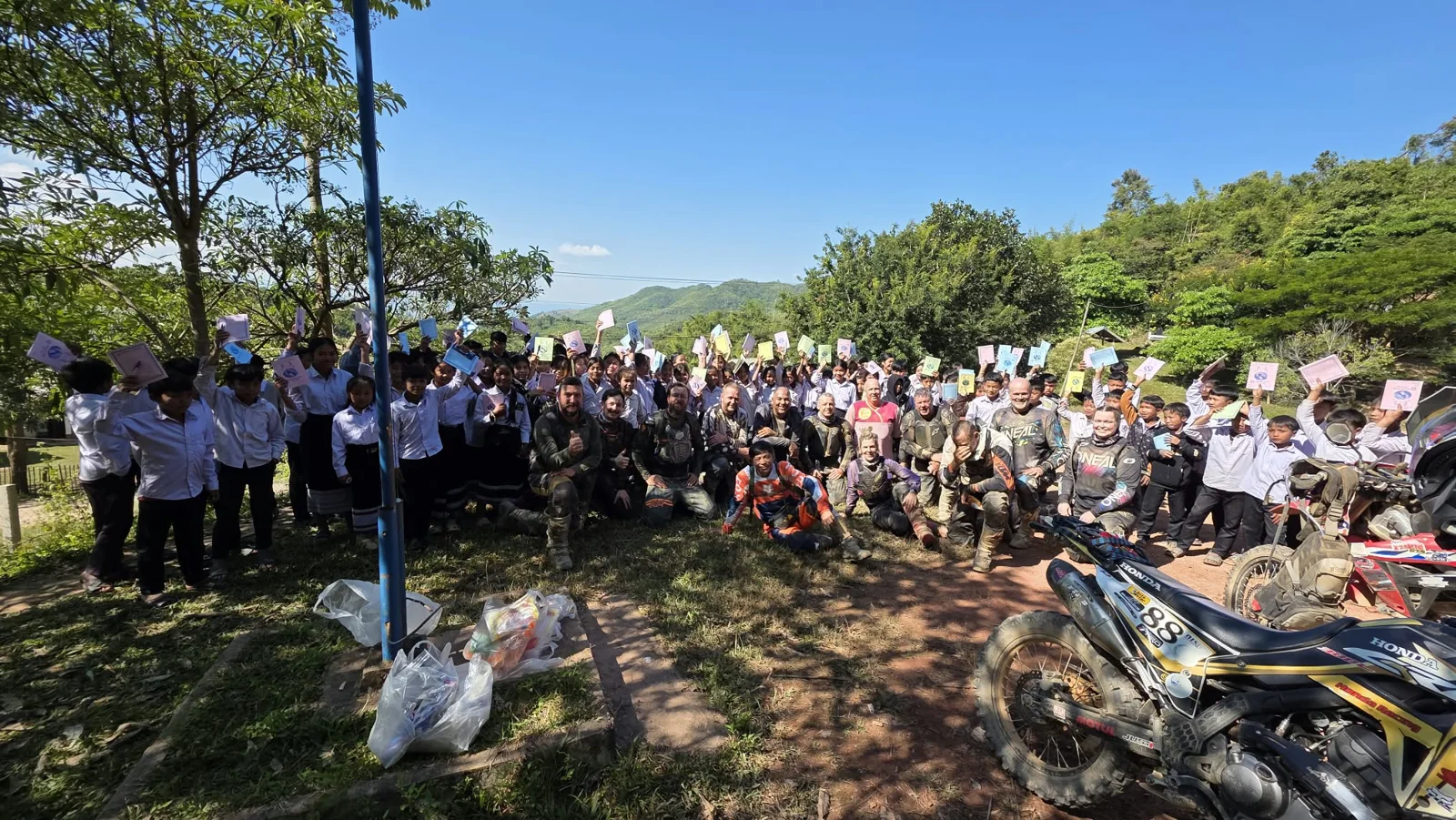 Riders and local people gathered outdoors.