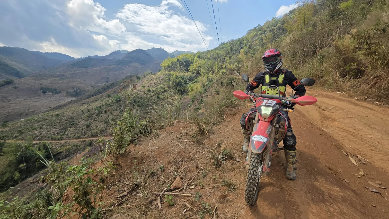 A rider following a mountain dirt road.