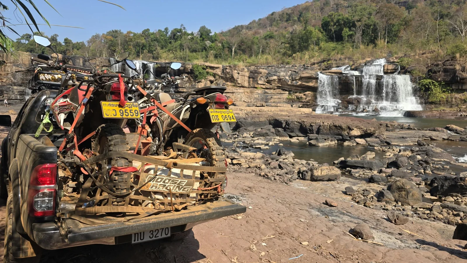 A dirt bike beside a waterfall viewpoint.