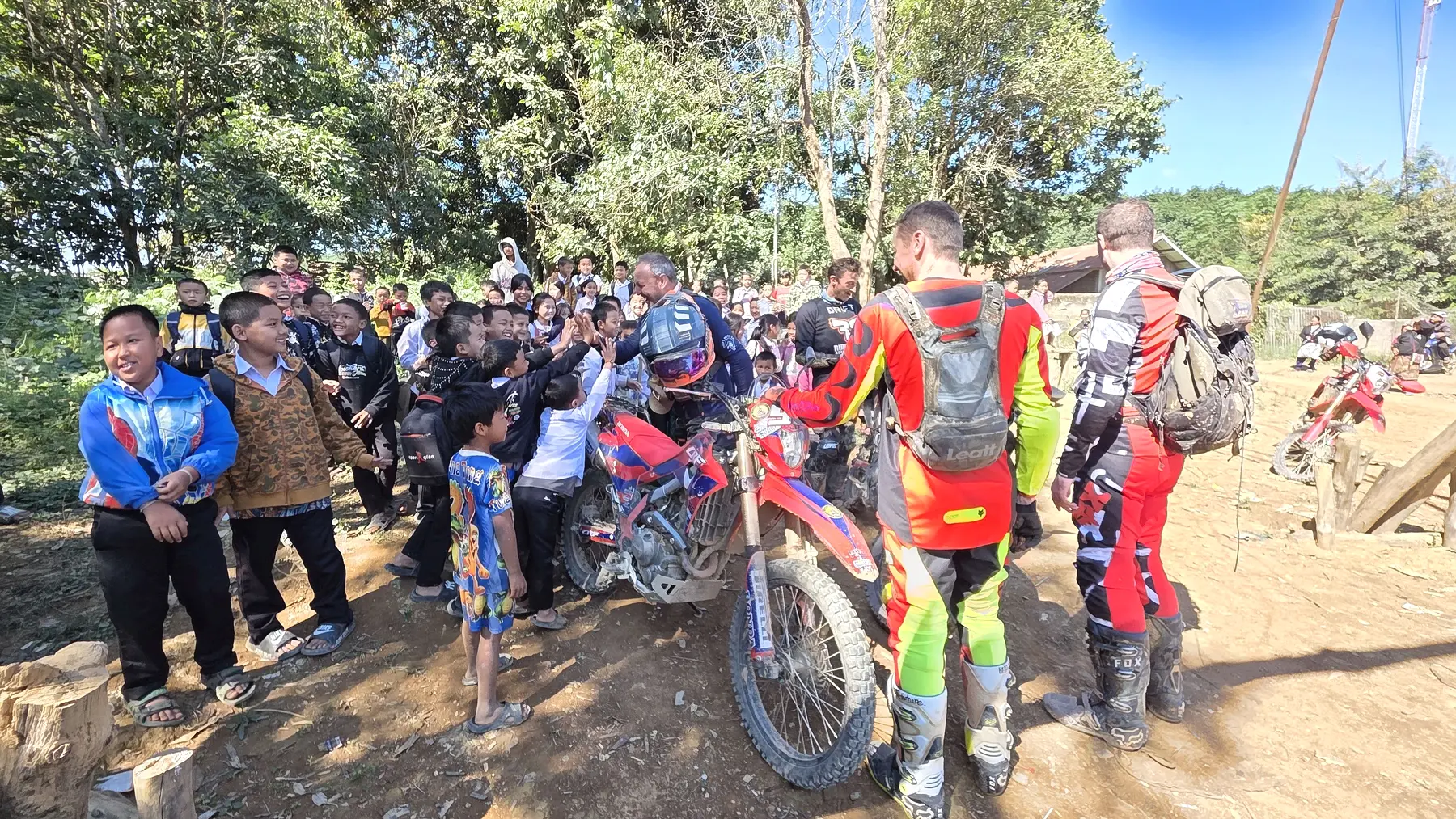 Dirt bike riders meeting local people in northern Laos